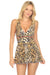 Woman wearing an animal-printed skirted one piece swimsuit with v-neck from Johnny Was
