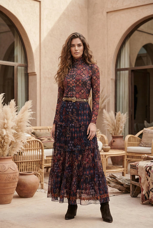 Woman wearing floral geometric printed mesh maxi skirt with tiered ruffles and embroidery from Johnny Was