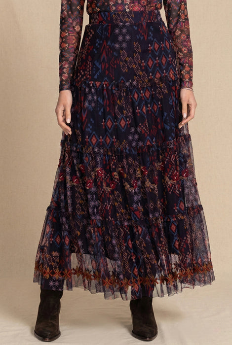 Woman wearing floral geometric printed mesh maxi skirt with tiered ruffles and embroidery from Johnny Was
