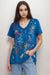 Woman wearing a blue Arizona-inspired embroidered t-shirt with v-neck and short sleeves from Johnny Was