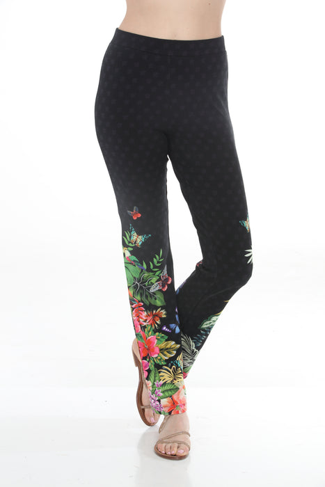 Woman wearing a black straight leg leggings with colorful tropical floral print from Johnny Was