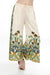 Woman wearing a cream-colored wide leg pants with floral print and drawstring waistband from Johnny Was