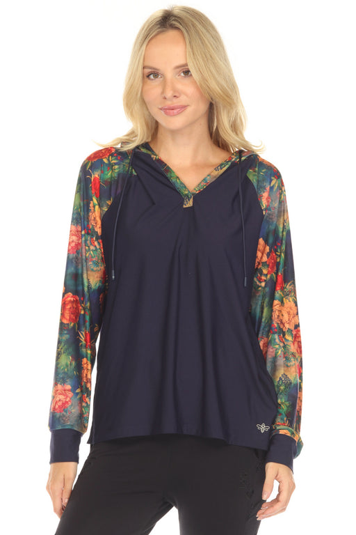 Woman wearing a navy hoodie with colorful floral raglan sleeves from Johnny Was