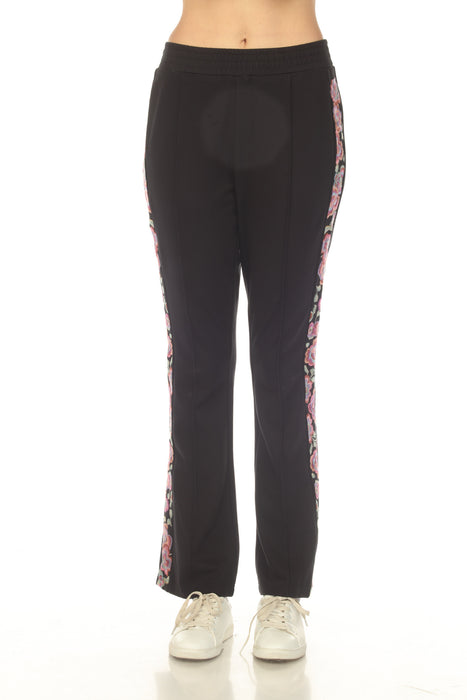 Woman wearing a black sweatpants with elastic waistband and embroidered sides from Johnny Was