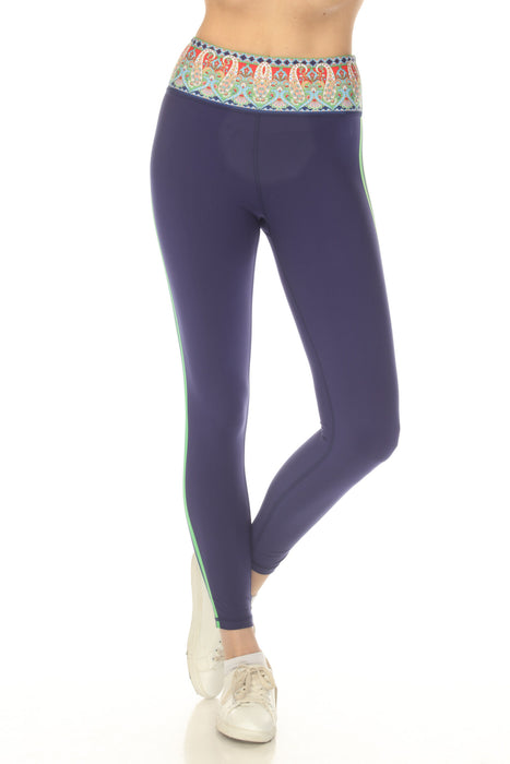 Woman wearing a navy legging with paisley-printed high waist and green side stripes from Johnny Was