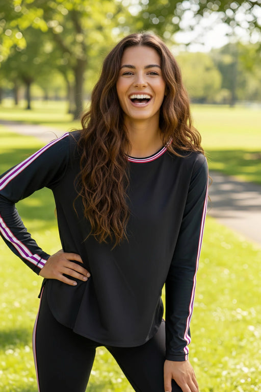 Woman wearing a black oversized crop tee with striped crew neck and long sleeves from Johnny Was