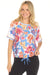 Woman wearing a colorful floral activewear top with drawstring hem from Johnny Was