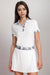 Woman wearing a white polo tee with printed trim on the button placket and sleeve cuffs from Johnny Was