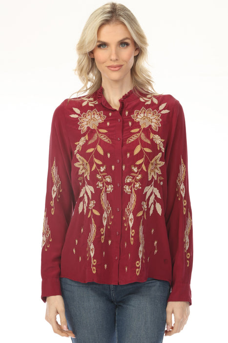 Woman wearing a red-colored long sleeve blouse with gold floral embroidery from Johnny Was