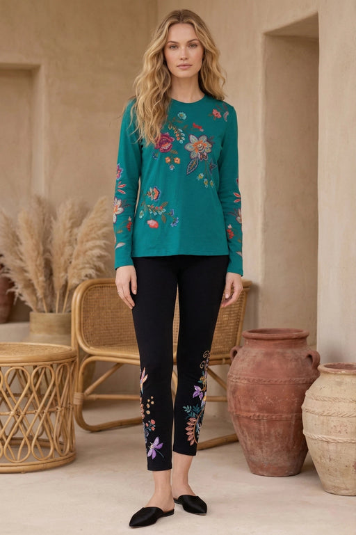 Woman wearing a black embroidered leggings from Johnny Was