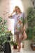 Woman modeling lilac boho silk shift dress with tropical and animal print design