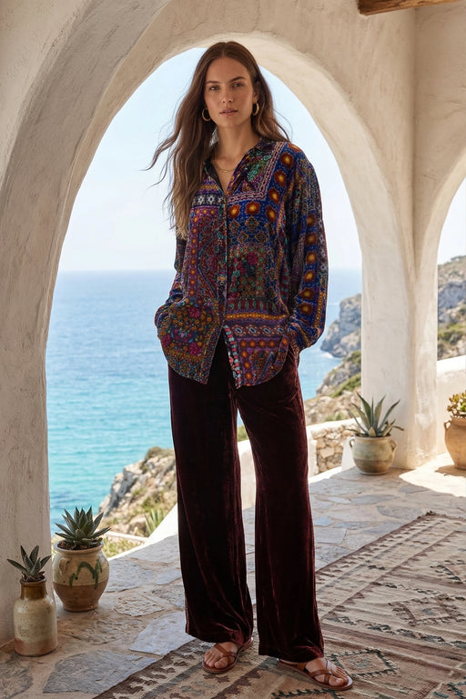 Woman wearing a button down long sleeve tunic shirt with intricate patchwork pattern from Johnny Was