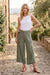 Woman wearing a green wide leg crop cargo pants with belt from Johnny Was