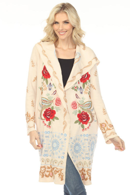 Woman wearing a cream-colored long cardigan with floral embroidery and hood from Johnny Was