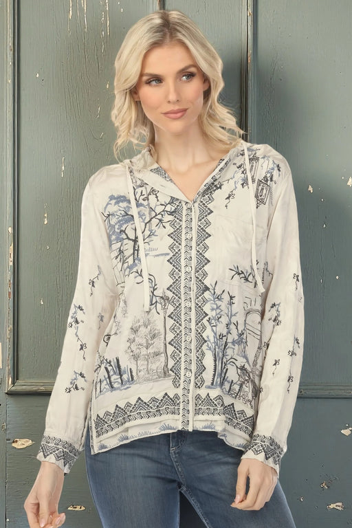 Woman wearing a patterned silver jacket with embroidery and hood from Johnny Was