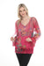 Woman wearing a pink printed mesh top with lace trim and split v-neck with tie from Johnny Was
