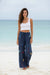 Woman wearing a navy blue embroidered wide leg pant with drawstring elastic waistband from Johnny Was