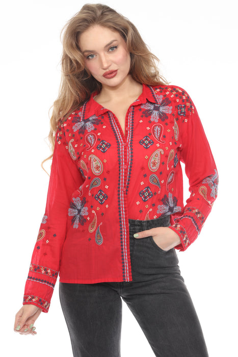 Woman wearing a red shirt with vibrant paisley embroideries, button down, and long sleeves