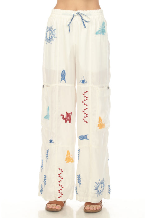 Woman wearing a white embroidered wide leg pant with drawstring elastic waistband from Johnny Was