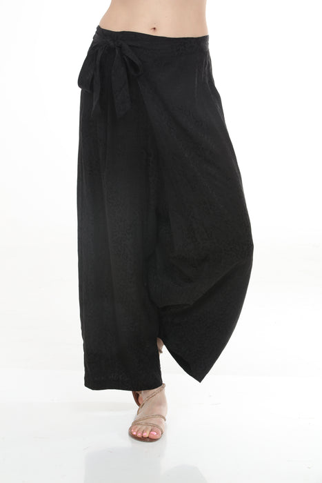 Woman wearing a black animal printed wide leg pants with elastic waistband from Johnny Was