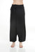 Woman wearing a black animal printed wide leg pants with elastic waistband from Johnny Was