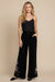 Woman wearing a black embroidered wide leg velvet pants from Johnny Was