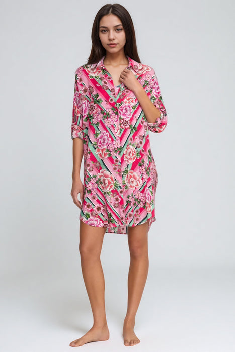 Woman wearing a pink button down shirt dress with florals and stripes pattern from Johnny Was