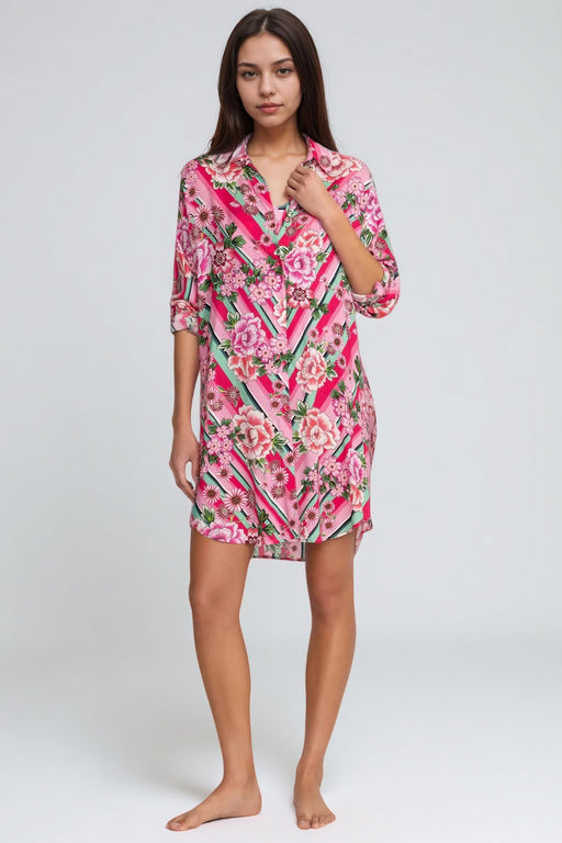 Woman wearing a pink button down shirt dress with florals and stripes pattern from Johnny Was