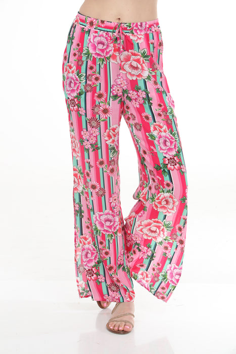 Woman wearing a colorful wide leg split pants with florals over stripes from Johnny Was