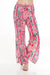 Woman wearing a colorful wide leg split pants with florals over stripes from Johnny Was