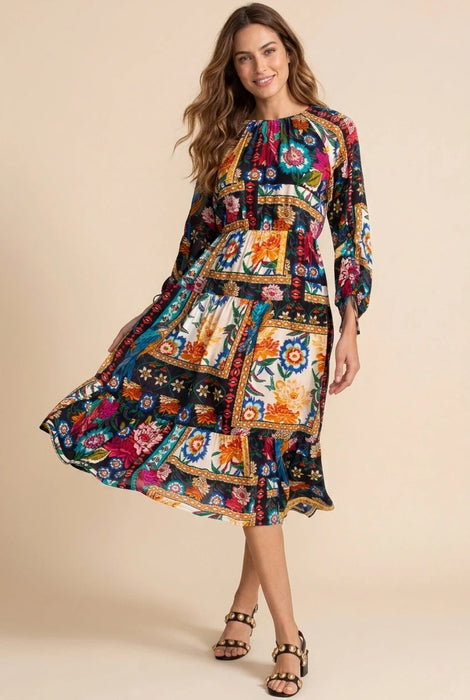 Woman wearing a colorful floral patchwork patterned midi dress with 3/4 sleeves from Johnny Was