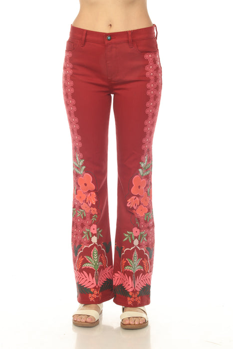 Model wearing a red floral-printed jean with slightly flared silhouette from Johnny Was
