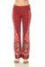 Model wearing a red floral-printed jean with slightly flared silhouette from Johnny Was