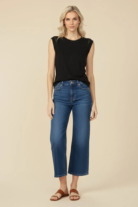 Woman wearing a black crew neck sleeveless top with crochet detail on the armholes from Johnny Was