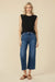 Woman wearing a black crew neck sleeveless top with crochet detail on the armholes from Johnny Was