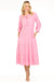 Woman wearing a pink midi dress with smocked waist and tiered skirt from Johnny Was