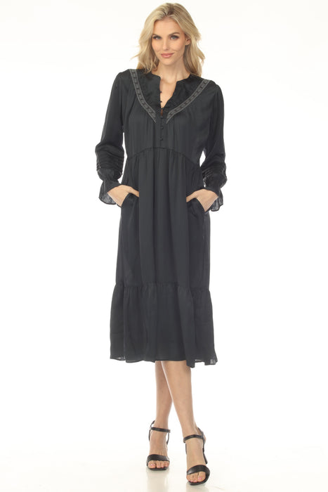 Woman wearing a navy midi dress with henley neckline and pleated accent from Johnny Was