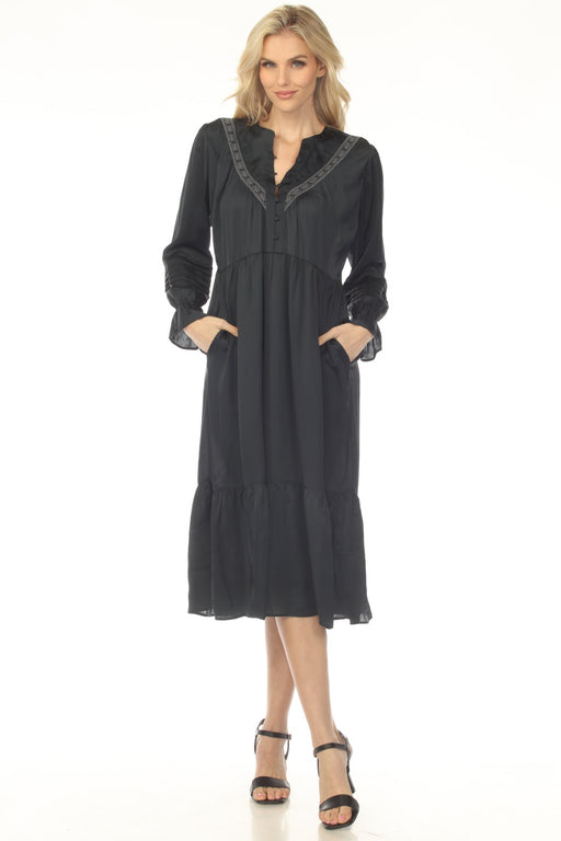 Woman wearing a navy midi dress with henley neckline and pleated accent from Johnny Was