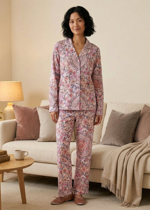 Woman wearing Johnny Was Carly PJ Set Aussie Long Sleeve featuring a soft floral print, button-front top, and relaxed pants, styled for cozy and elegant loungewear.