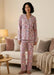 Woman wearing Johnny Was Carly PJ Set Aussie Long Sleeve featuring a soft floral print, button-front top, and relaxed pants, styled for cozy and elegant loungewear.