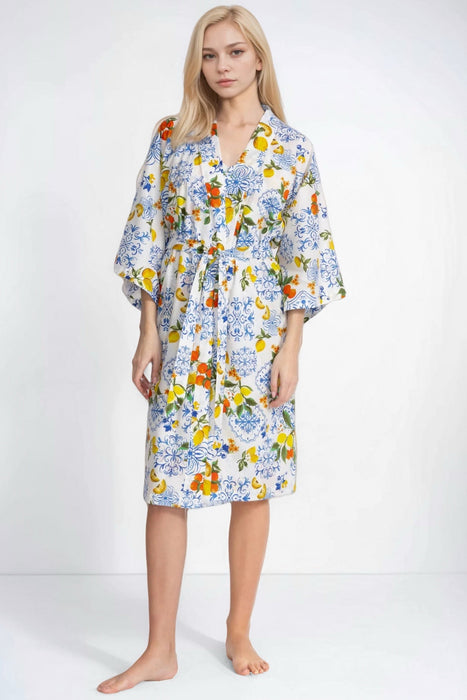 Woman wearing a vibrant citrus printed sleep robe from Johnny Was