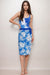 Woman wearing a blue swim wrap coverup skirt with floral pattern from Johnny Was