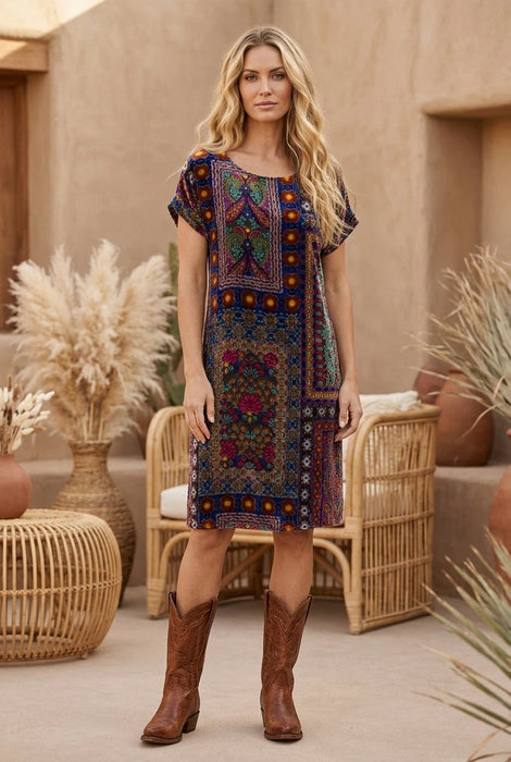 Woman wearing a colorful burnout patterned shift dress with short dolman sleeves from Johnny Was