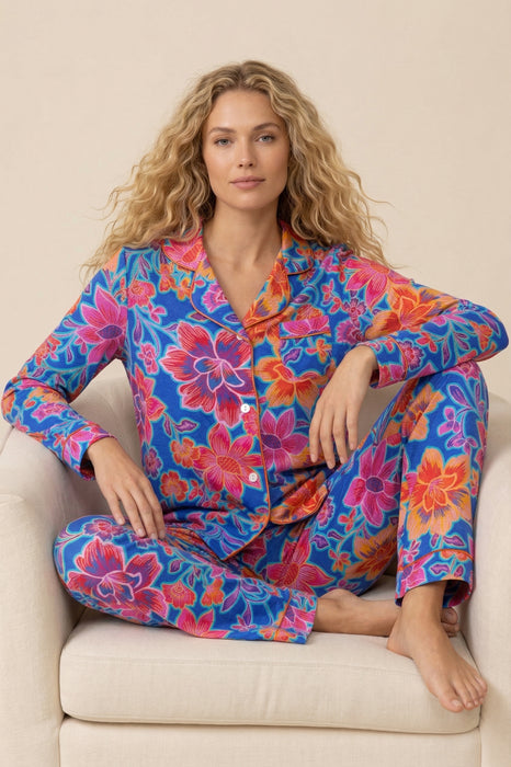 Woman wearing Johnny Was Carly PJ Set floral cotton blend pajamas, women’s long sleeve button-front top with elastic waist pants, colorful luxury loungewear set
