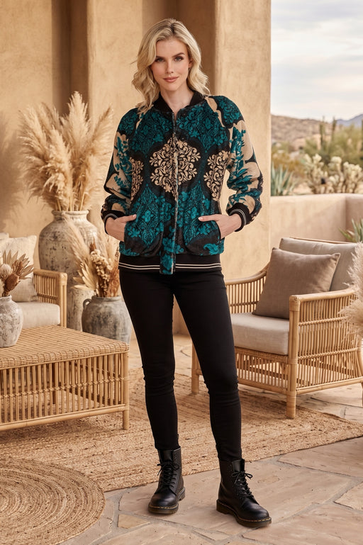 Woman wearing a patterned bomber jacket with stripe ribbed edges from Johnny Was