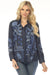 Woman wearing a dark blue embroidered shirt with button down front from Johnny Was