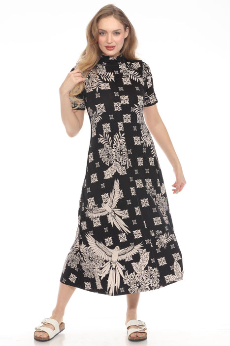 Woman wearing a black midi dress with mock neck and intricate patterns