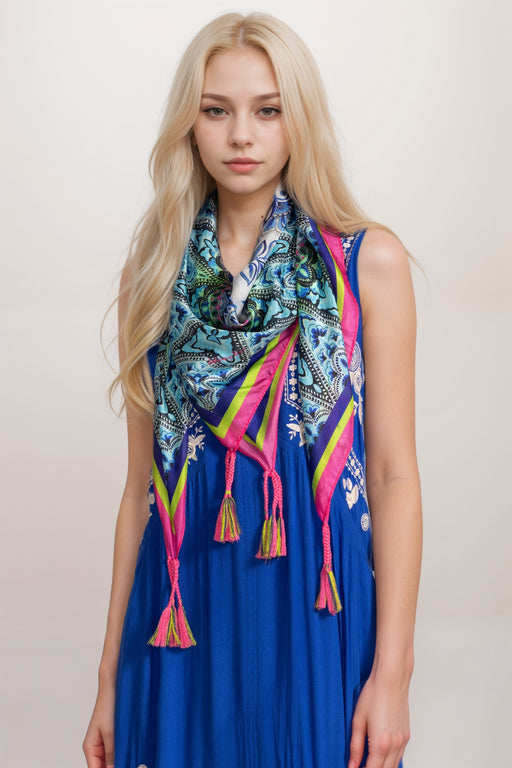 Woman wearing a colorful silk scarf with tassels from Johnny Was