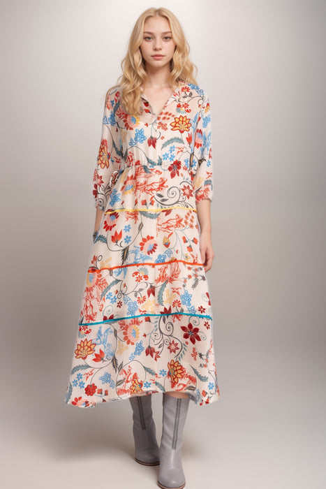 Woman wearing a vibrant midi floral dress with split v-neck and 3/4 sleeves