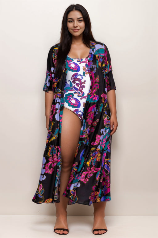 Woman wearing a black kimono swimsuit cover up with colorful paisley pattern and ruffle trims from Johnny Was